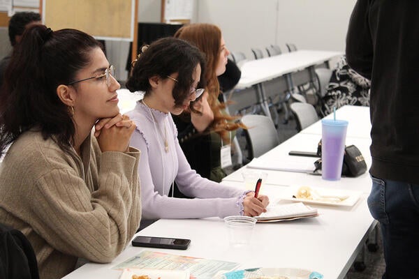 People sitting at a table during a lecture