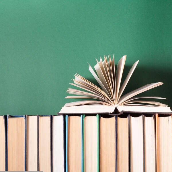 An open book on a bookshelf